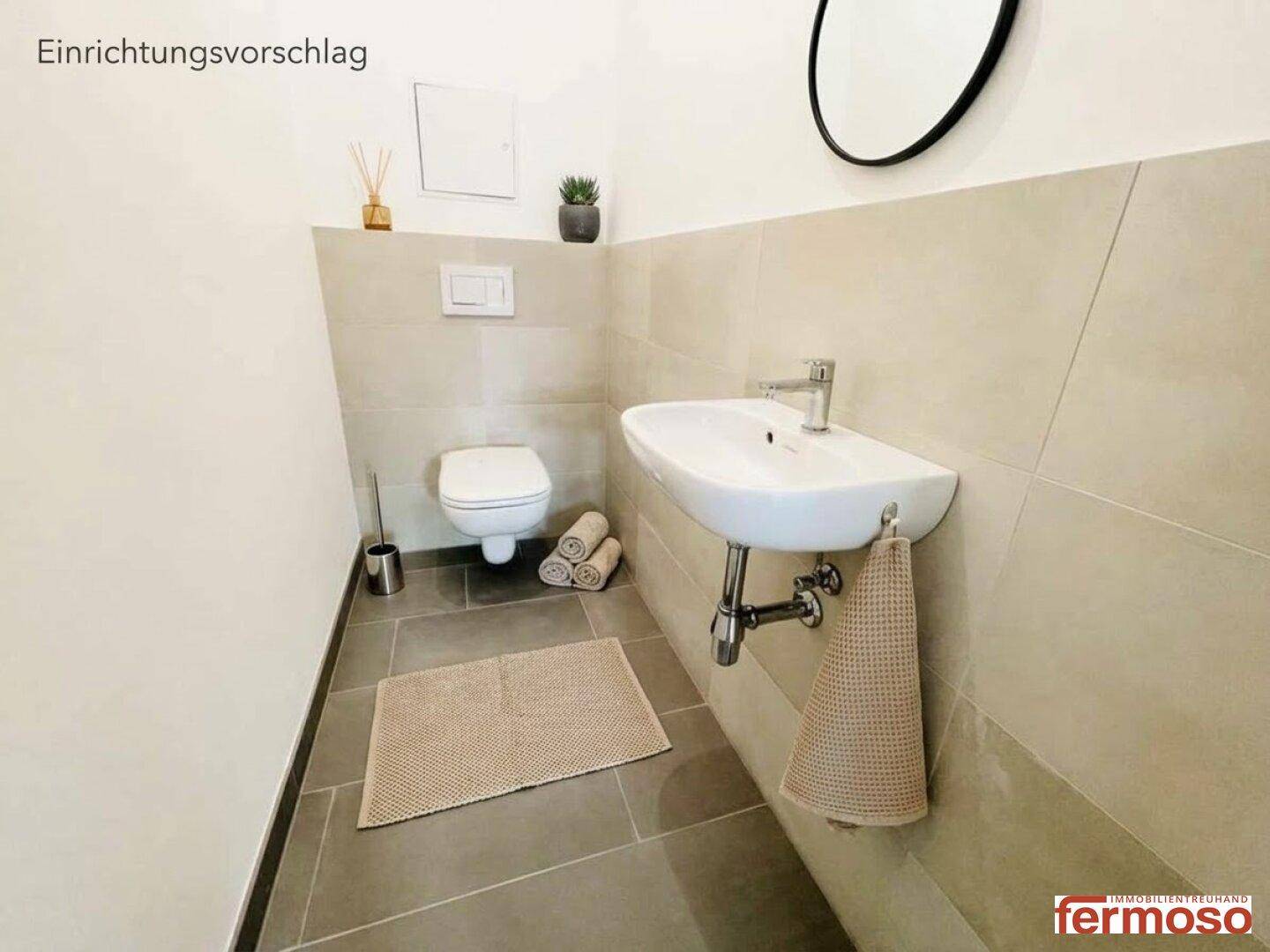 Modernes Gäste-WC mit Wand-WC, Waschbecken und grauen Fliesen.