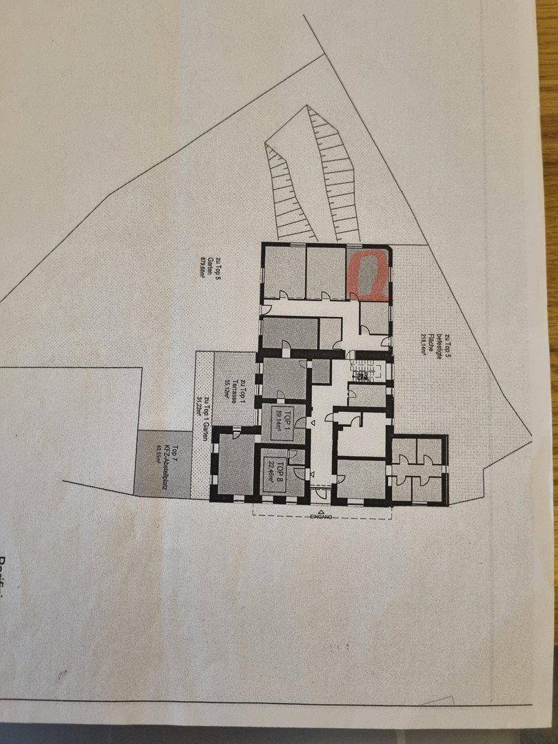 Übersichtsplan des Grundstücks mit Gebäudestruktur, Parkplätzen und Gartenbereichen.