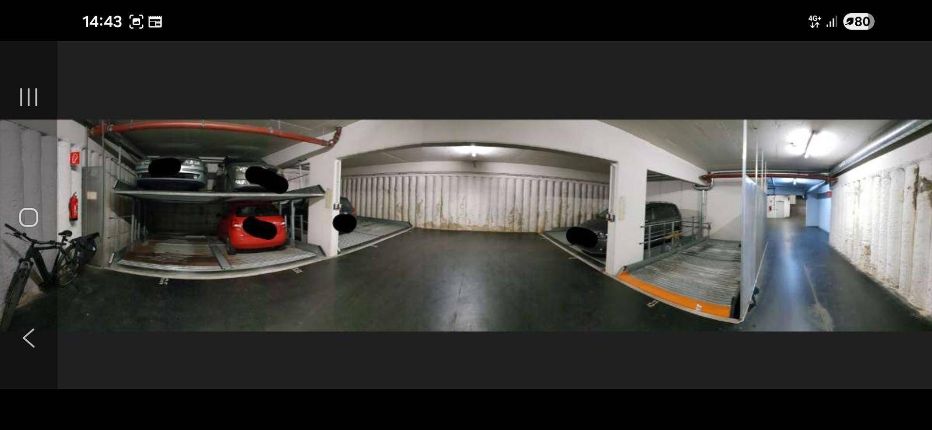 Panoramaansicht einer Tiefgarage mit mehreren Doppelparker-Stellplätzen und funktionaler Beleuchtung.
