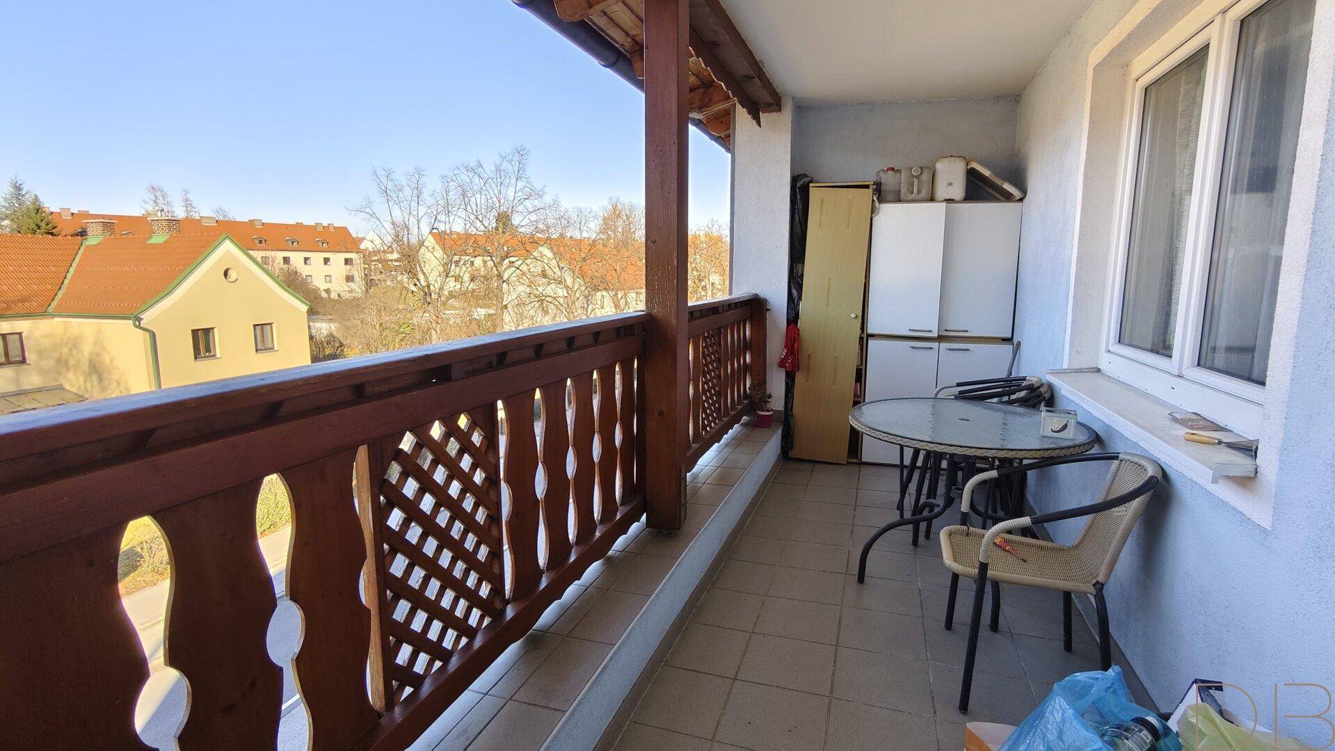 Balkon mit traditionellem Holzgeländer und Sitzgelegenheiten, bietet einen schönen Ausblick.