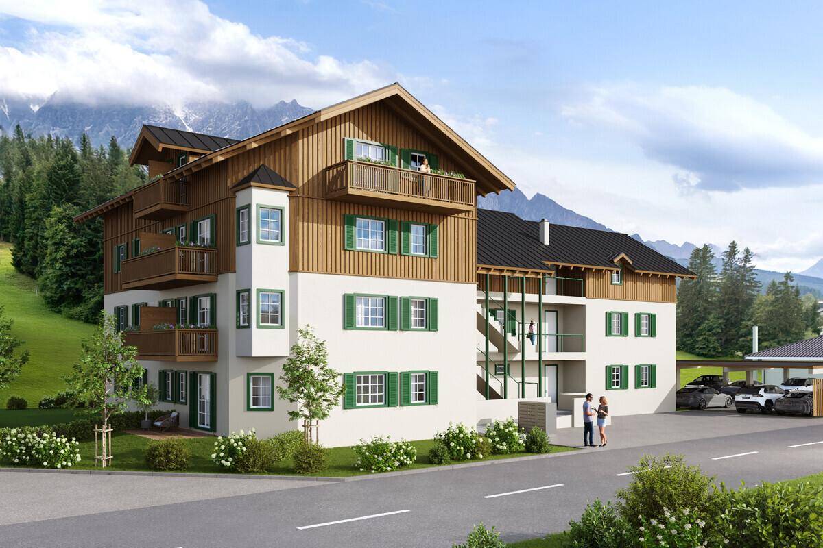 Neubau im alpinen Stil mit Holzverkleidung, Balkonen und Zugang zum Carport, eingebettet in eine Berglandschaft.