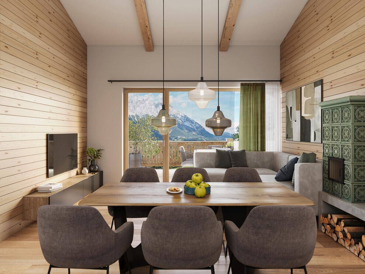Gemütlicher Wohn-Essbereich mit Kachelofen, Holzwänden und Zugang zum Balkon.