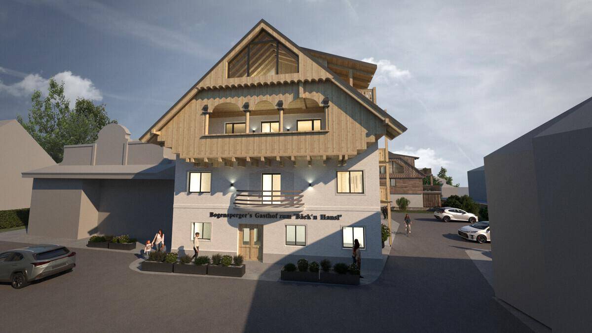 Fassade eines Neubaus im alpinen Stil mit Holzelementen und Balkonen.