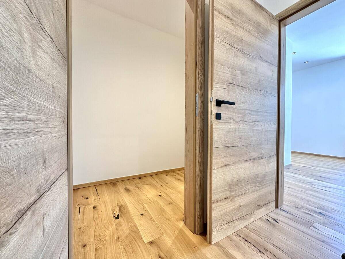 Kleiner Raum mit Holzboden, der als Abstellraum oder begehbarer Schrank dienen könnte.