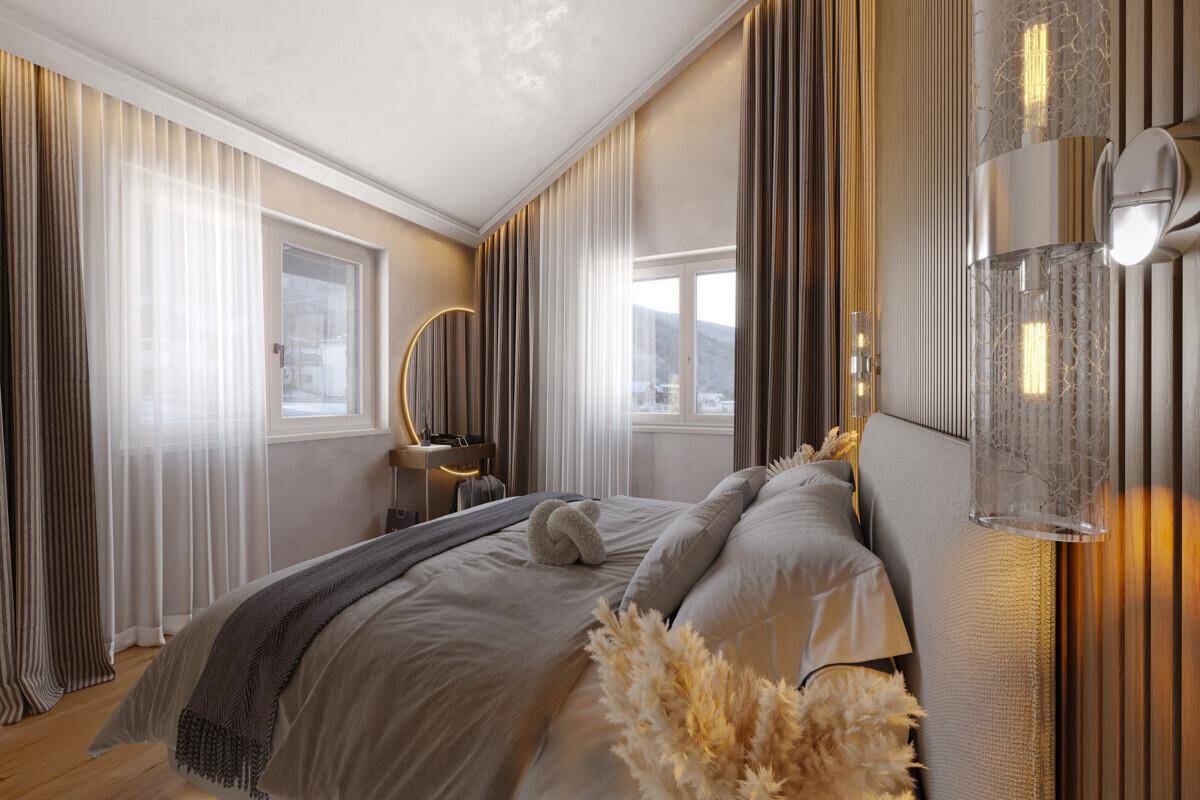 Gemütliches Schlafzimmer mit Doppelbett, moderner Einrichtung und zwei Fenstern mit Bergblick.