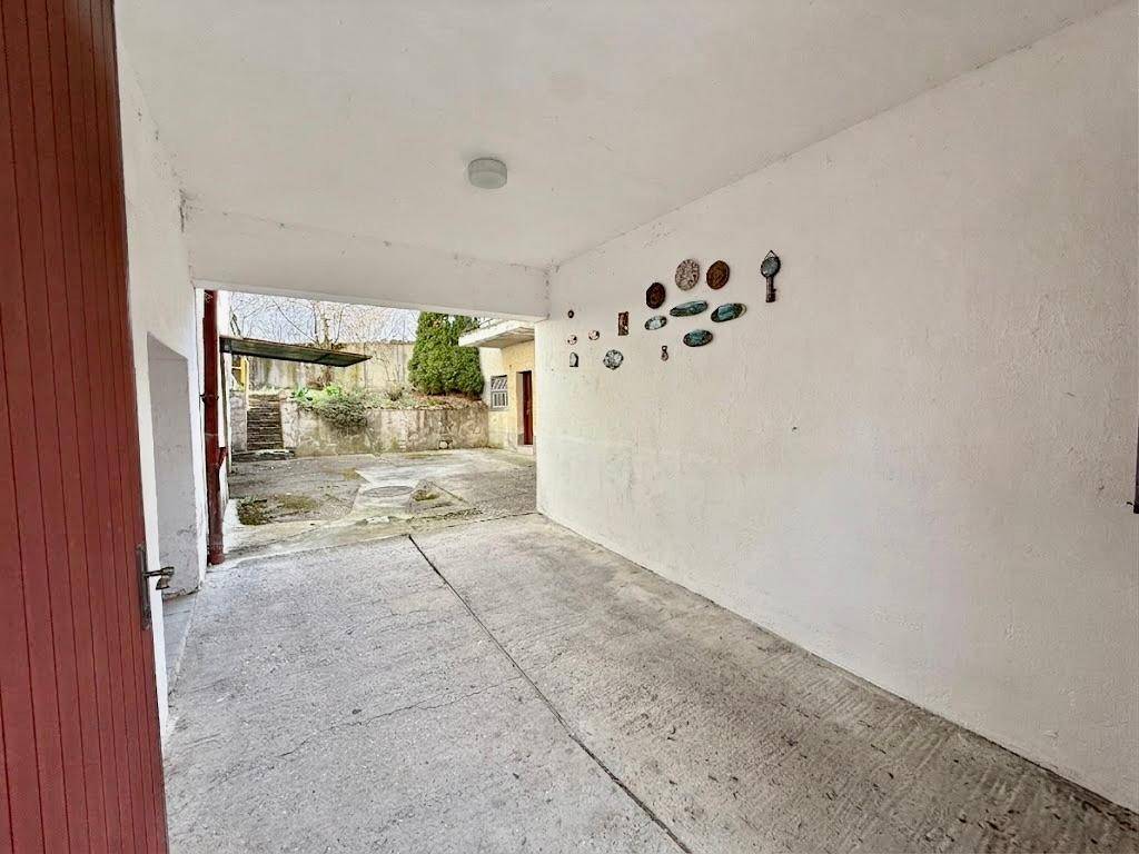 Überdachter Bereich, der als Carport oder Durchfahrt zum Hinterhof genutzt werden kann.