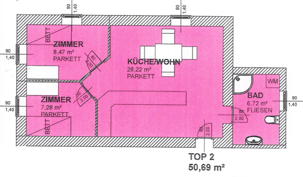 Grundriss der Wohnung "TOP 2" mit zwei Zimmern, einer offenen Wohnküche und einem Badezimmer.