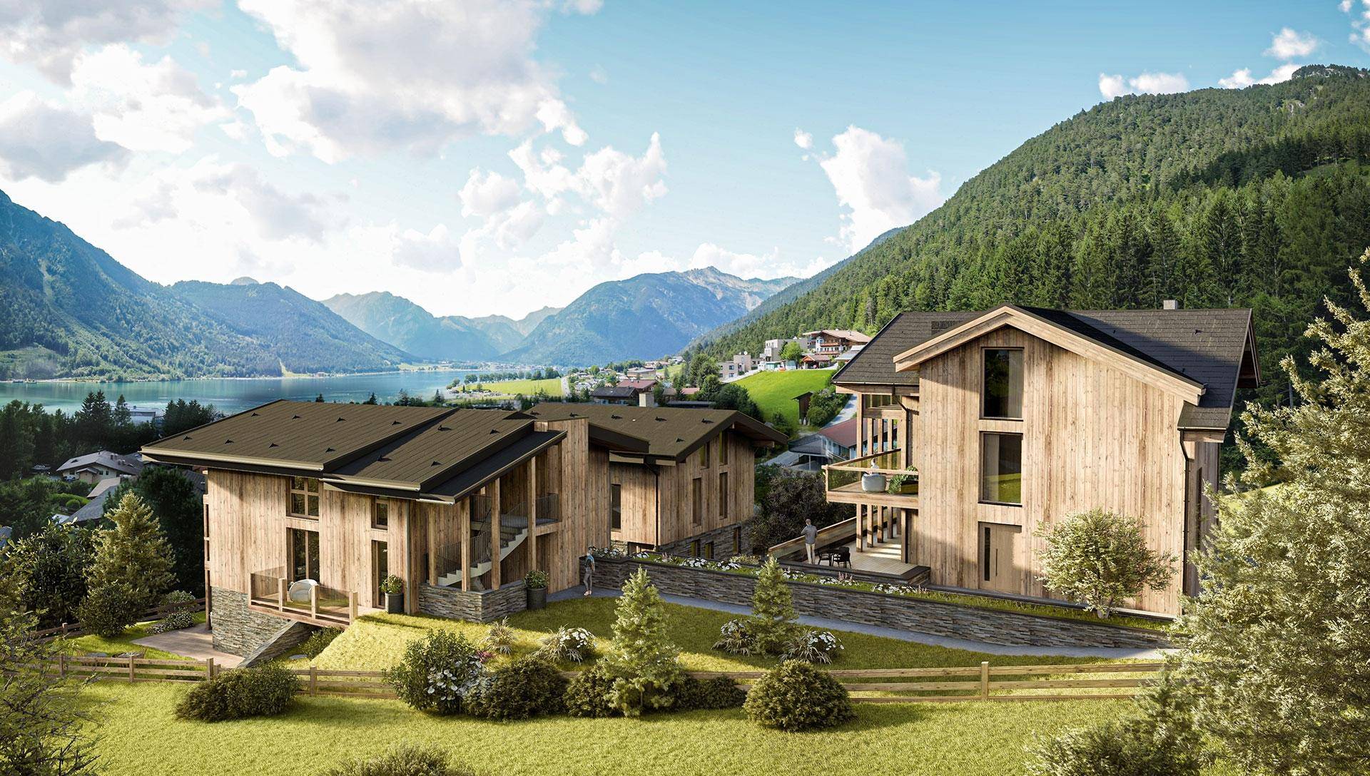 Moderne Chalets in idyllischer Berglandschaft mit Seeblick und viel Grün.