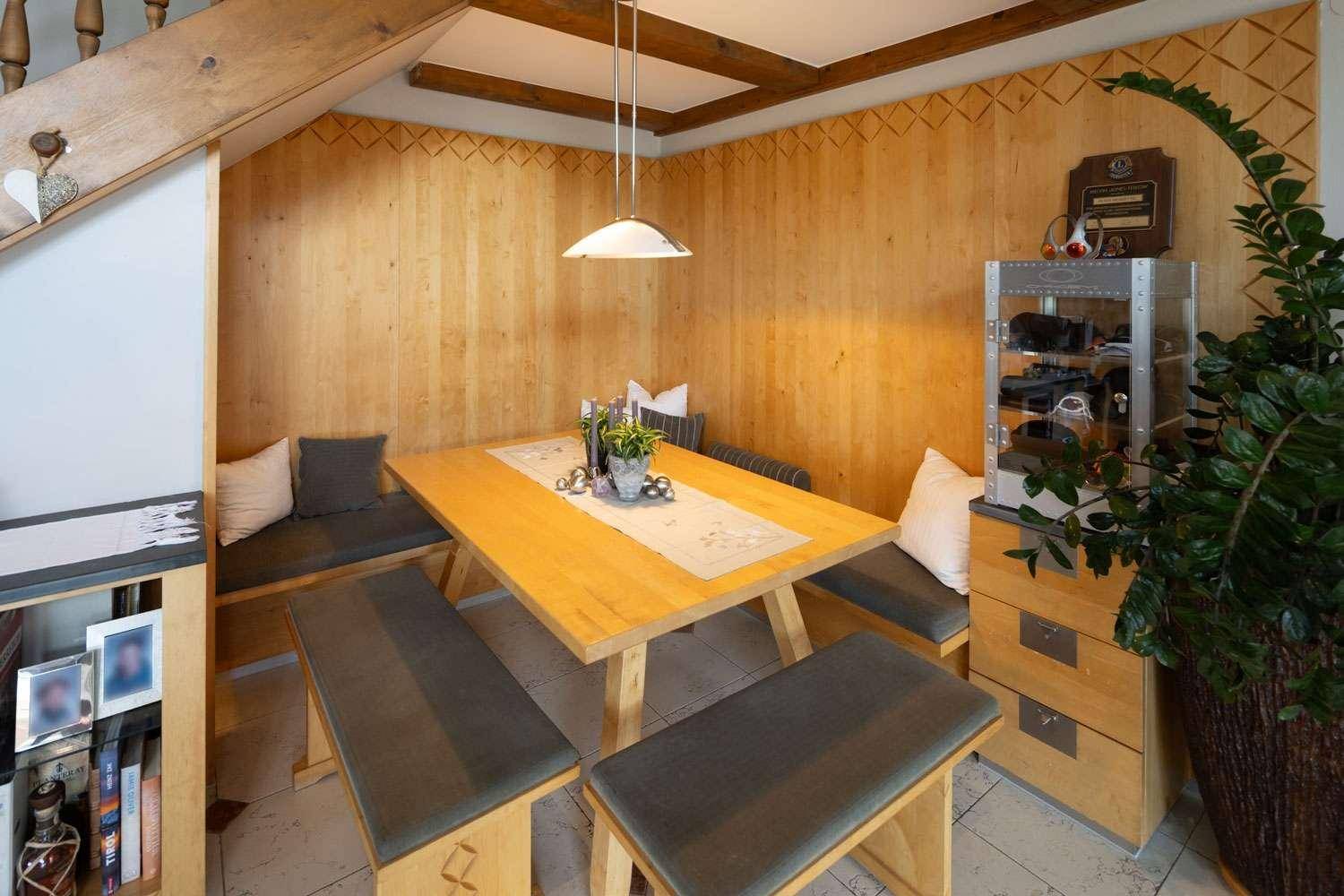 Traditioneller Essbereich mit Holztäfelung und gemütlichen Sitzbänken für gesellige Runden.