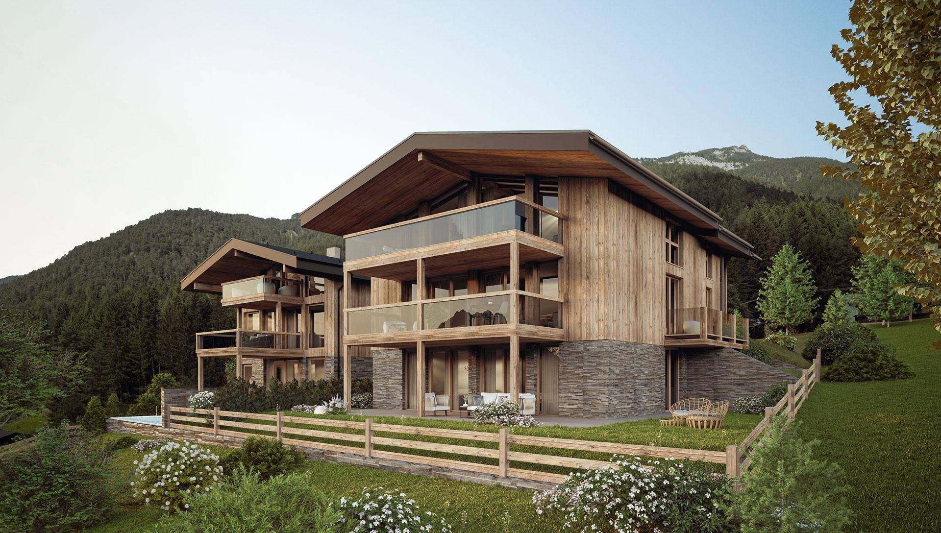 Attraktive Holzfassade mit Steinakzenten und Balkonen in alpiner Berglandschaft.