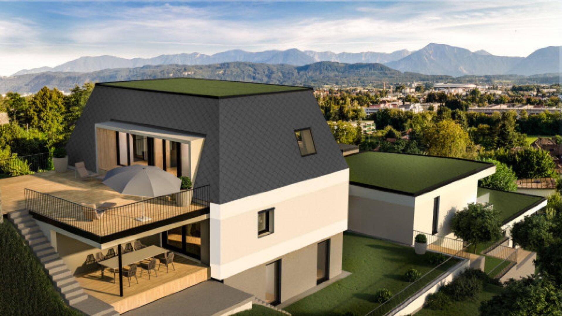 Modernes Haus mit großer Terrasse und beeindruckendem Bergblick in einer grünen Umgebung.