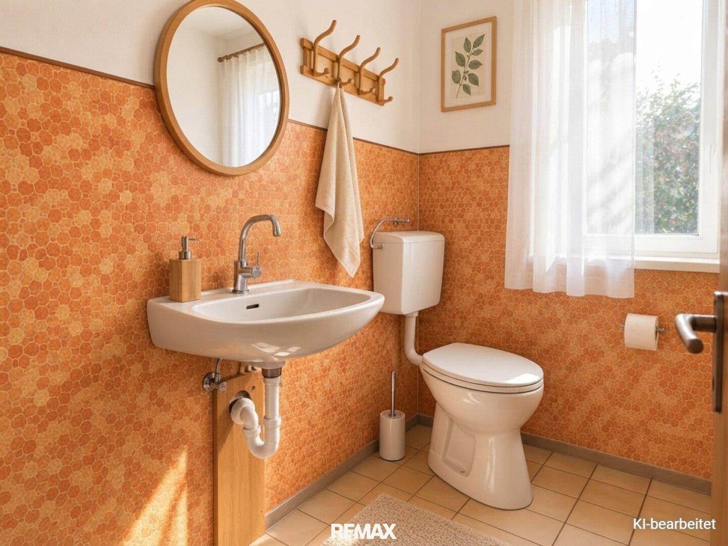 Gäste-WC mit Waschbecken, Toilette und Fenster für Tageslicht.