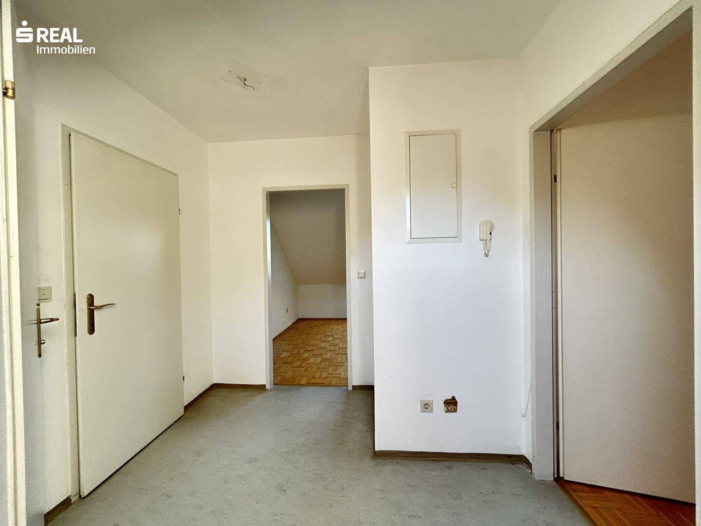 Geräumiger Flurbereich mit mehreren Türen und Zugang zu weiteren Zimmern.