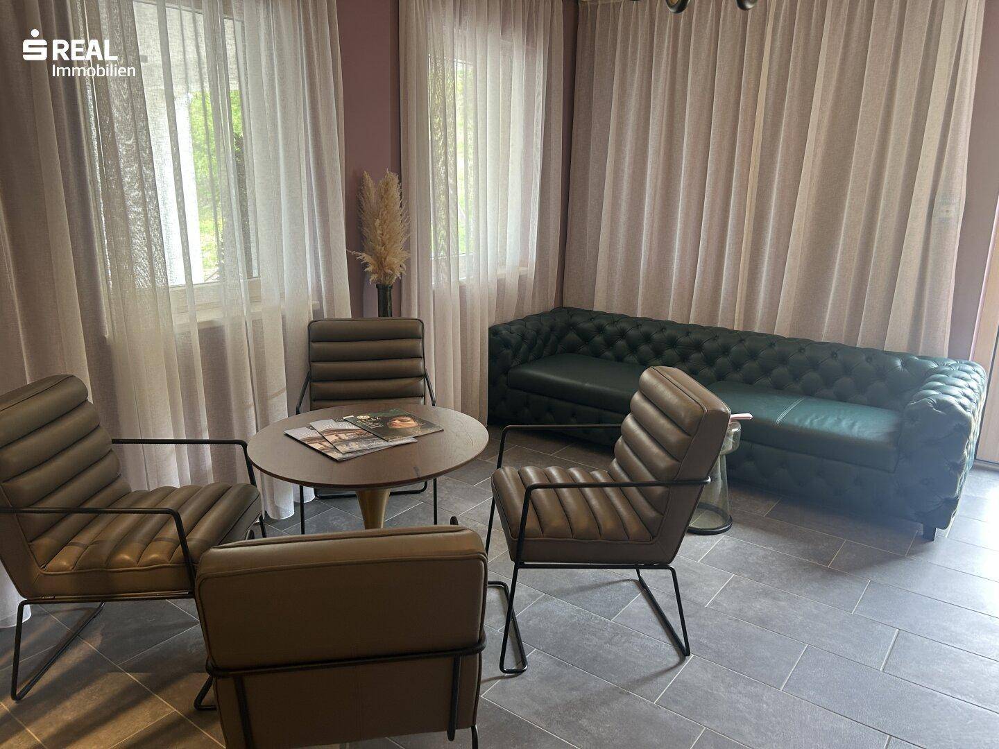 Stilvoller Loungebereich mit bequemen Ledersofas und Sesseln, ideal zum Entspannen.