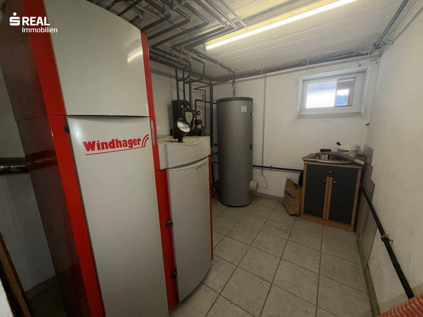 Heizraum im Keller mit einem modernen Windhager Heizsystem und Warmwasserspeicher.