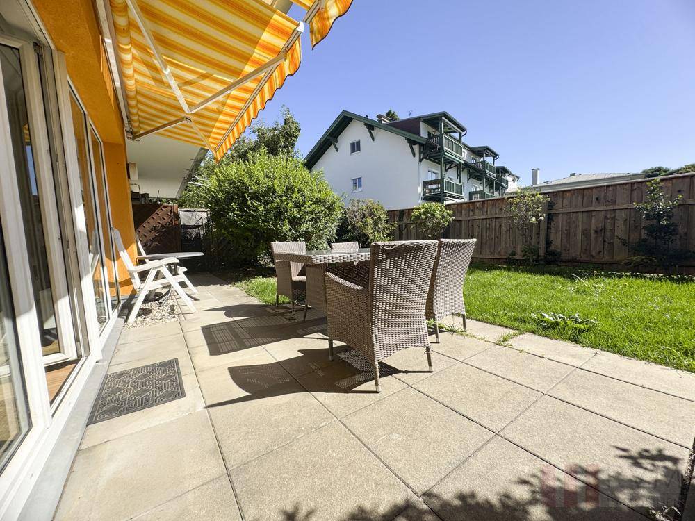 Geräumige Terrasse mit Gartenblick und Markise, perfekt für Mahlzeiten im Freien und Erholung.