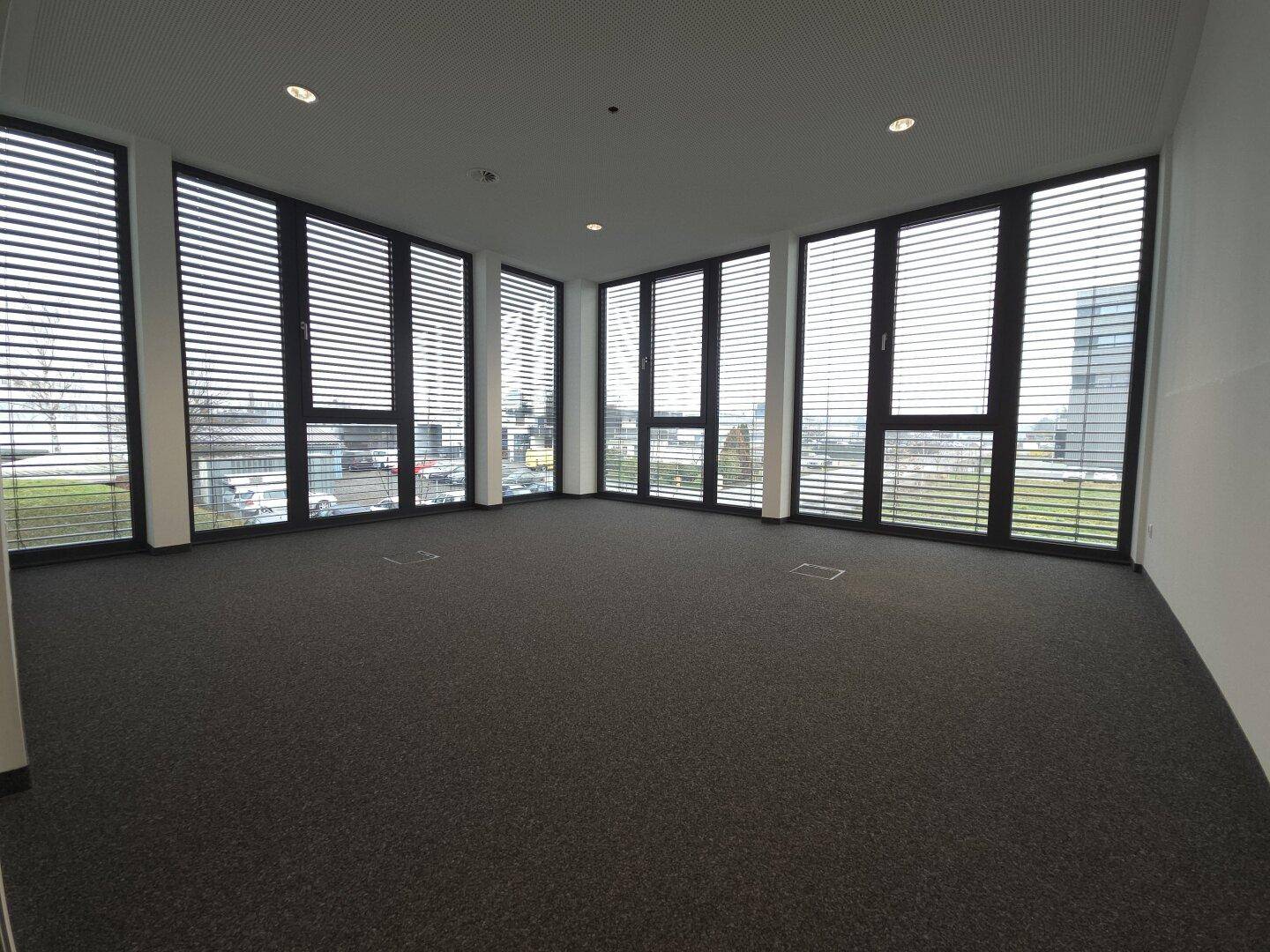 Eckbüro mit vielen Fenstern und Jalousien, bietet viel Tageslicht und Ausblick.