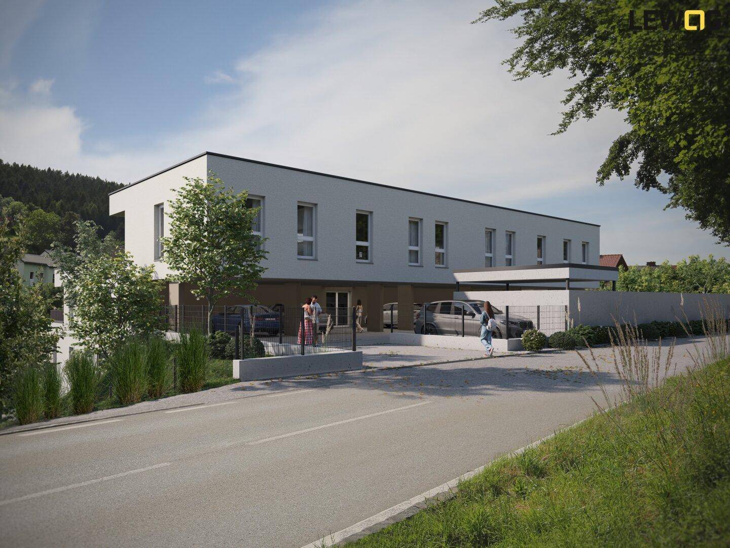 Moderne Gebäudefassade mit großen Fenstern und überdachten Parkplätzen an der Straße.