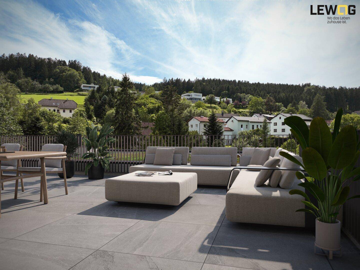 Großzügige Terrasse mit modernen Outdoor-Möbeln und weitem Blick auf die grüne Landschaft.