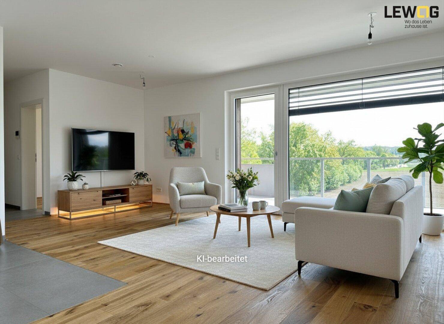 Helles, modern eingerichtetes Wohnzimmer mit Holzboden und Zugang zum Balkon mit Weitblick.
