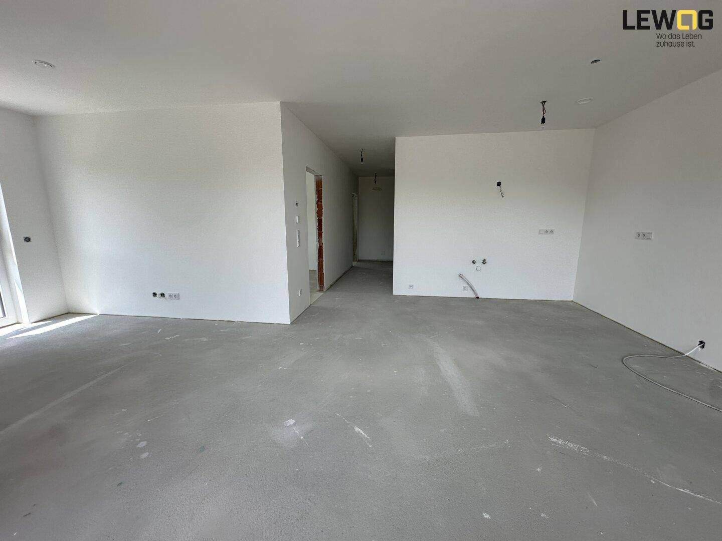 Geräumiger, unfertiger Wohnbereich mit viel Potenzial und blanken Wänden, bereit für die Gestaltung.