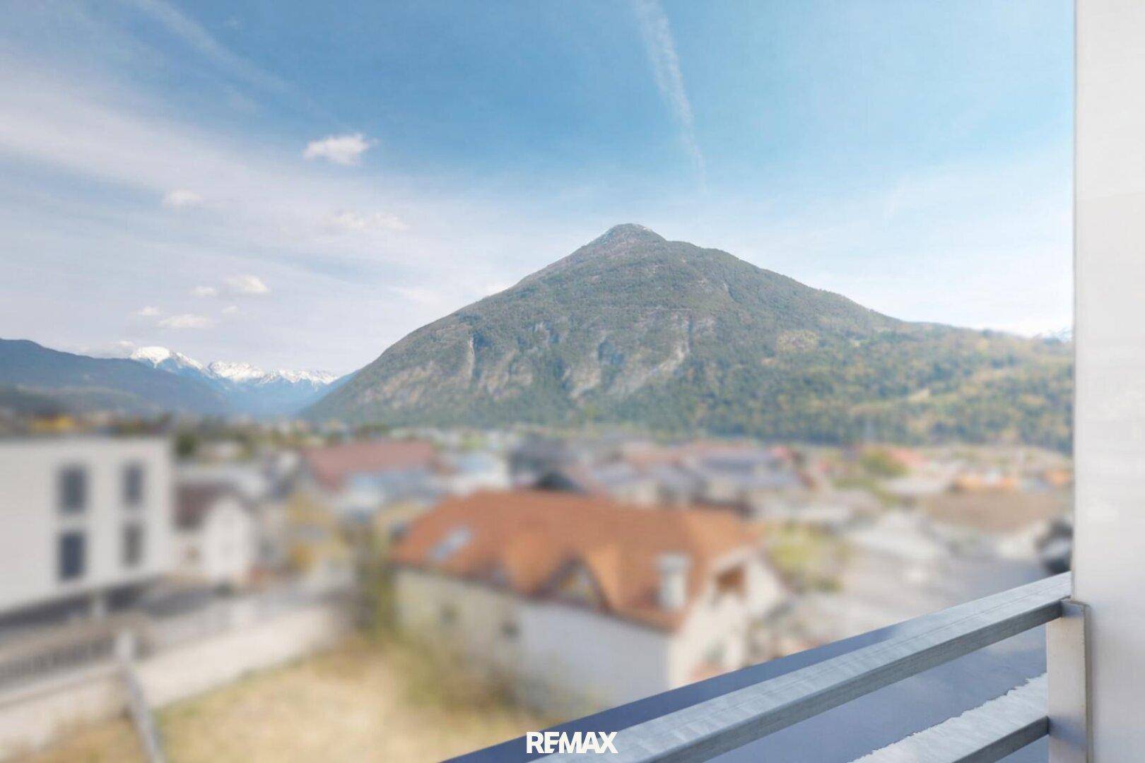 Atemberaubender Bergblick von einem Balkon, der eine malerische Landschaft mit schneebedeckten Gipfeln zeigt.