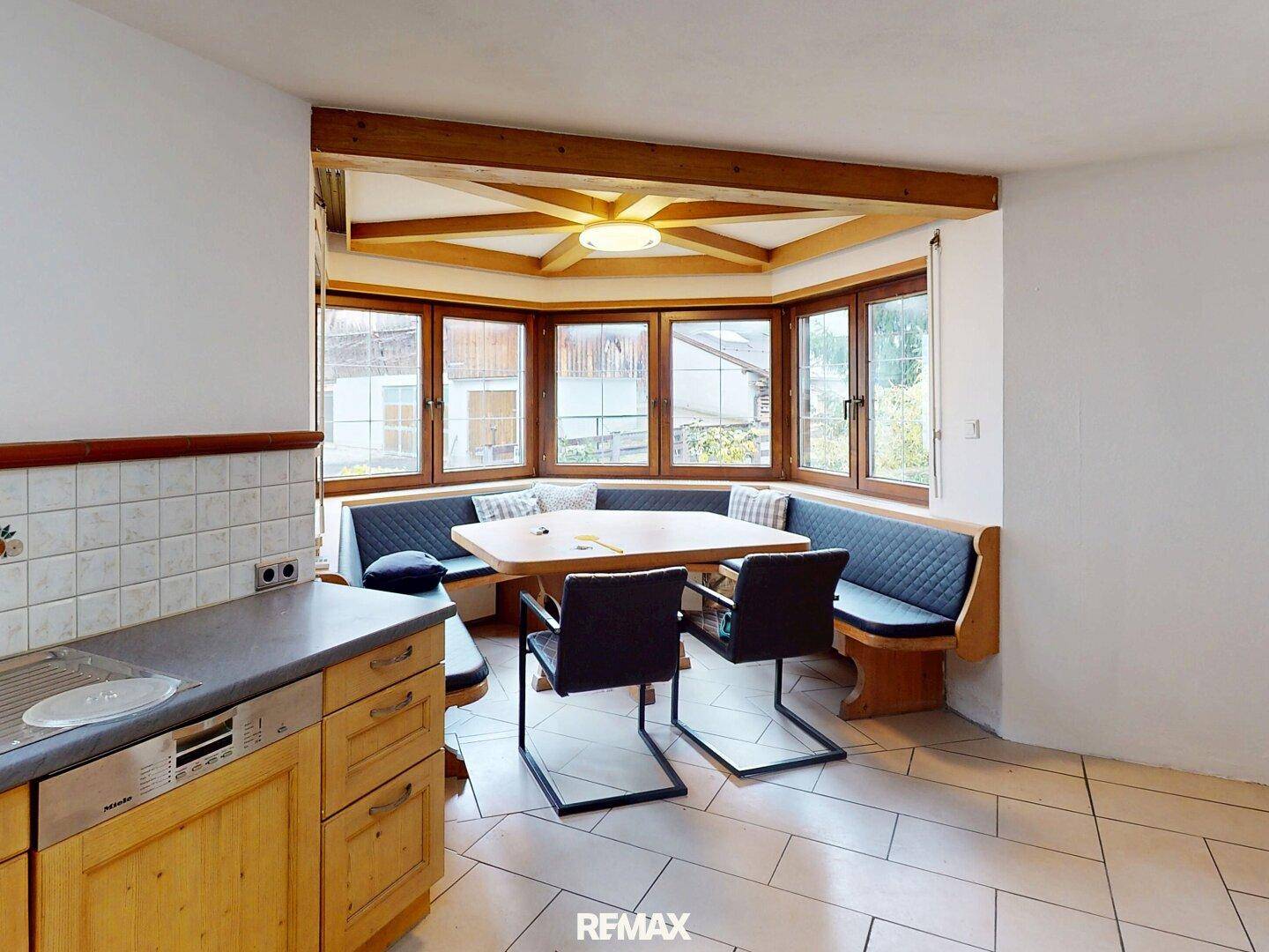 Helle Küche mit Essbereich, Einbauküche und traditionellen Fliesen, ideal für gemütliche Mahlzeiten.