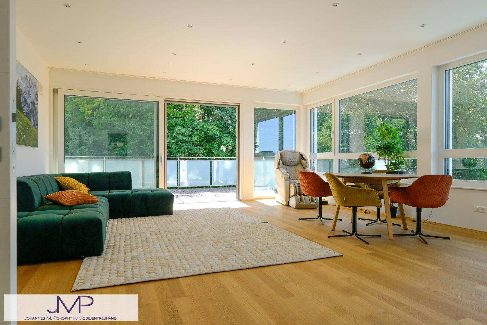 Geräumiger Wohn-Essbereich mit viel Tageslicht, modernem Interieur und Zugang zur Außenterrasse.