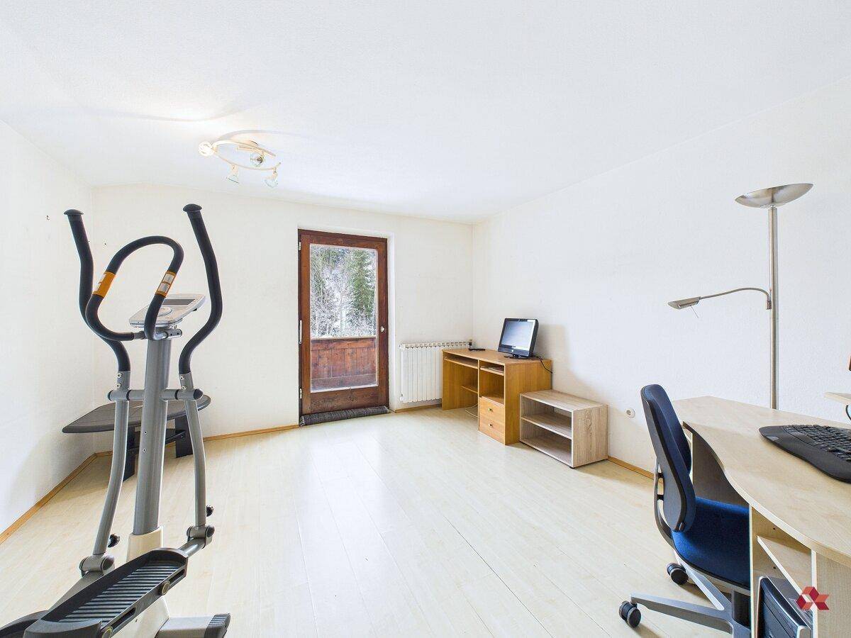 Vielseitiger Raum, nutzbar als Büro oder Fitnessbereich, mit Zugang nach draußen.