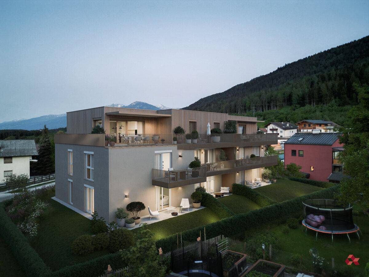 Neubau-Wohngebäude mit Terrassen und Balkonen in einer grünen Umgebung bei Dämmerung.