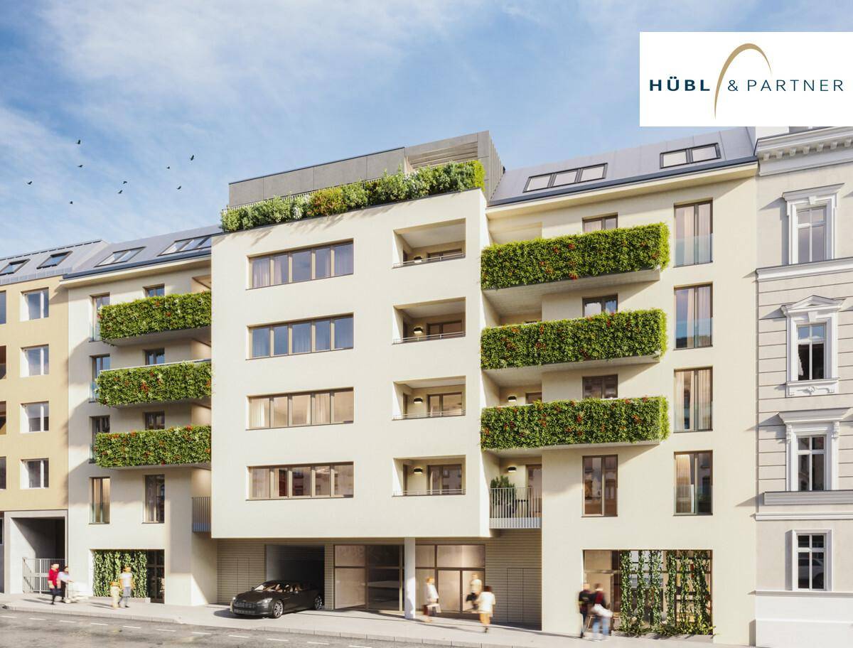 Moderne Wohnfassade mit begrünten Balkonen und Tiefgaragenzufahrt an der Straße.