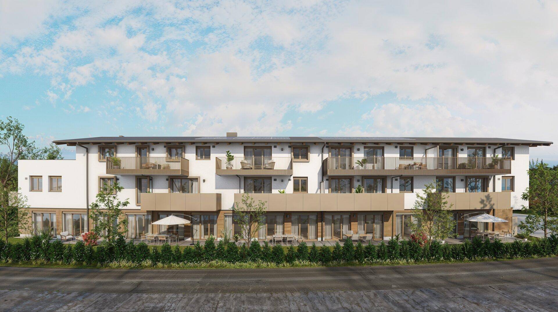 Seitenansicht der modernen Wohnanlage mit zahlreichen Balkonen und großzügigen Terrassenbereichen.