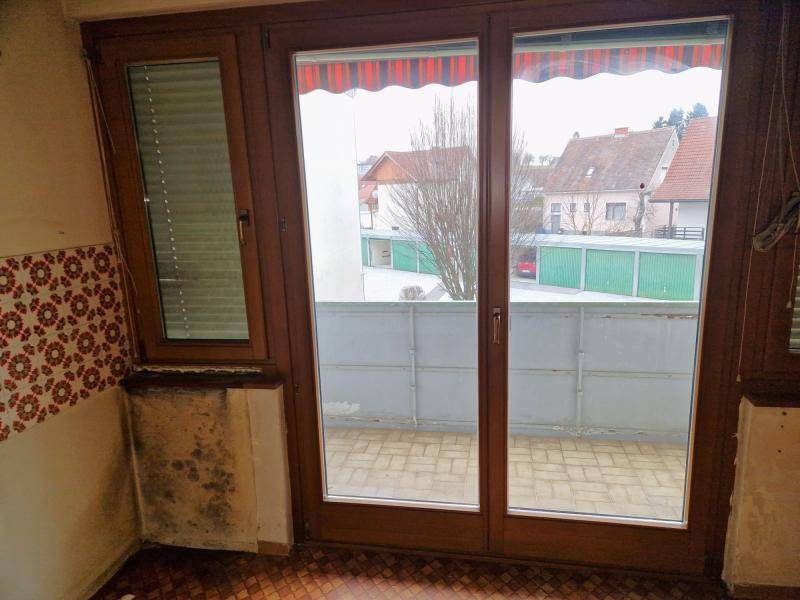 Balkon mit Fliesenboden und Blick auf die umliegenden Häuser und Garagen der Nachbarschaft.