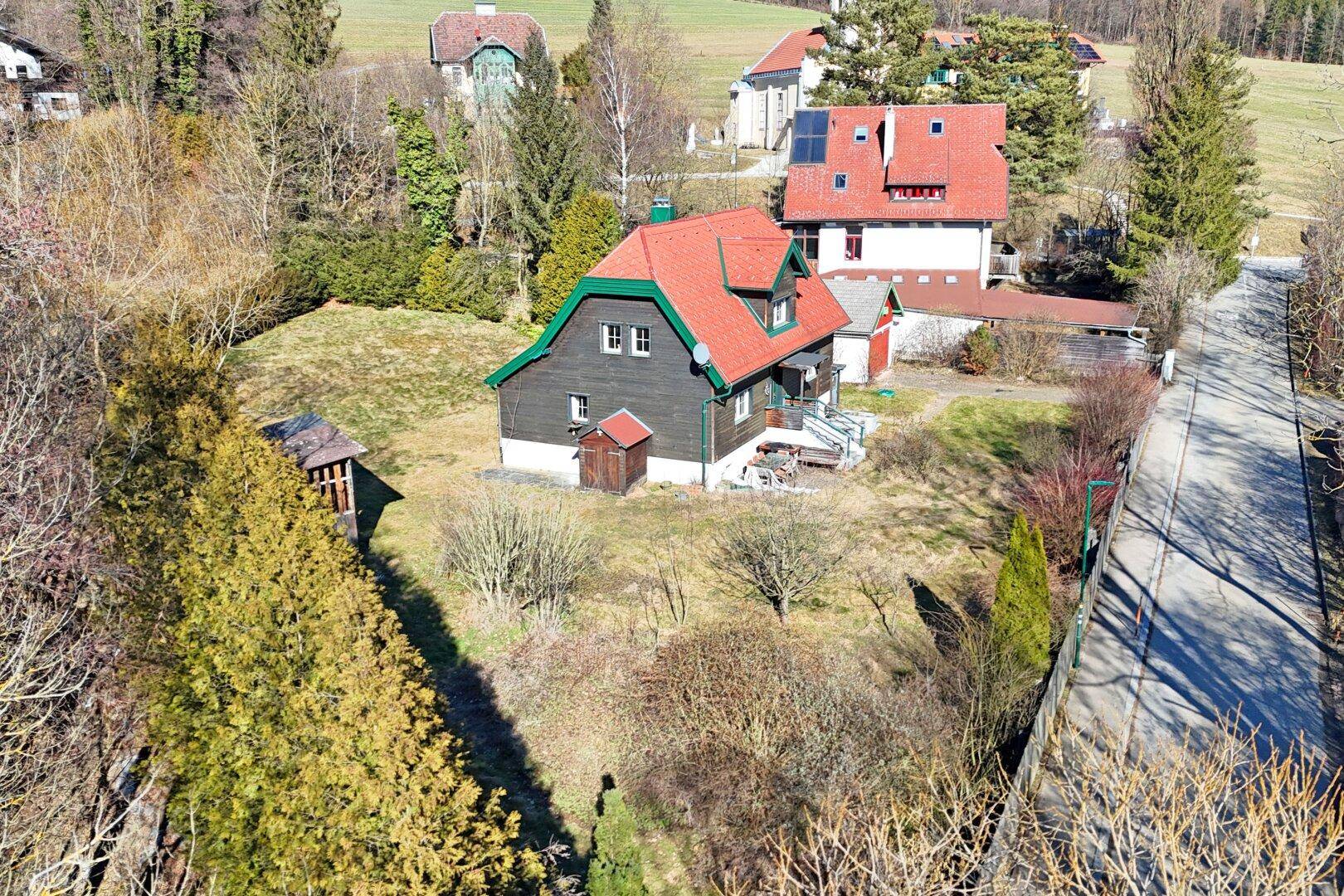 Luftaufnahme des Anwesens mit Einfamilienhaus, Nebengebäude und weitläufigem Grundstück in ländlicher Umgebung.