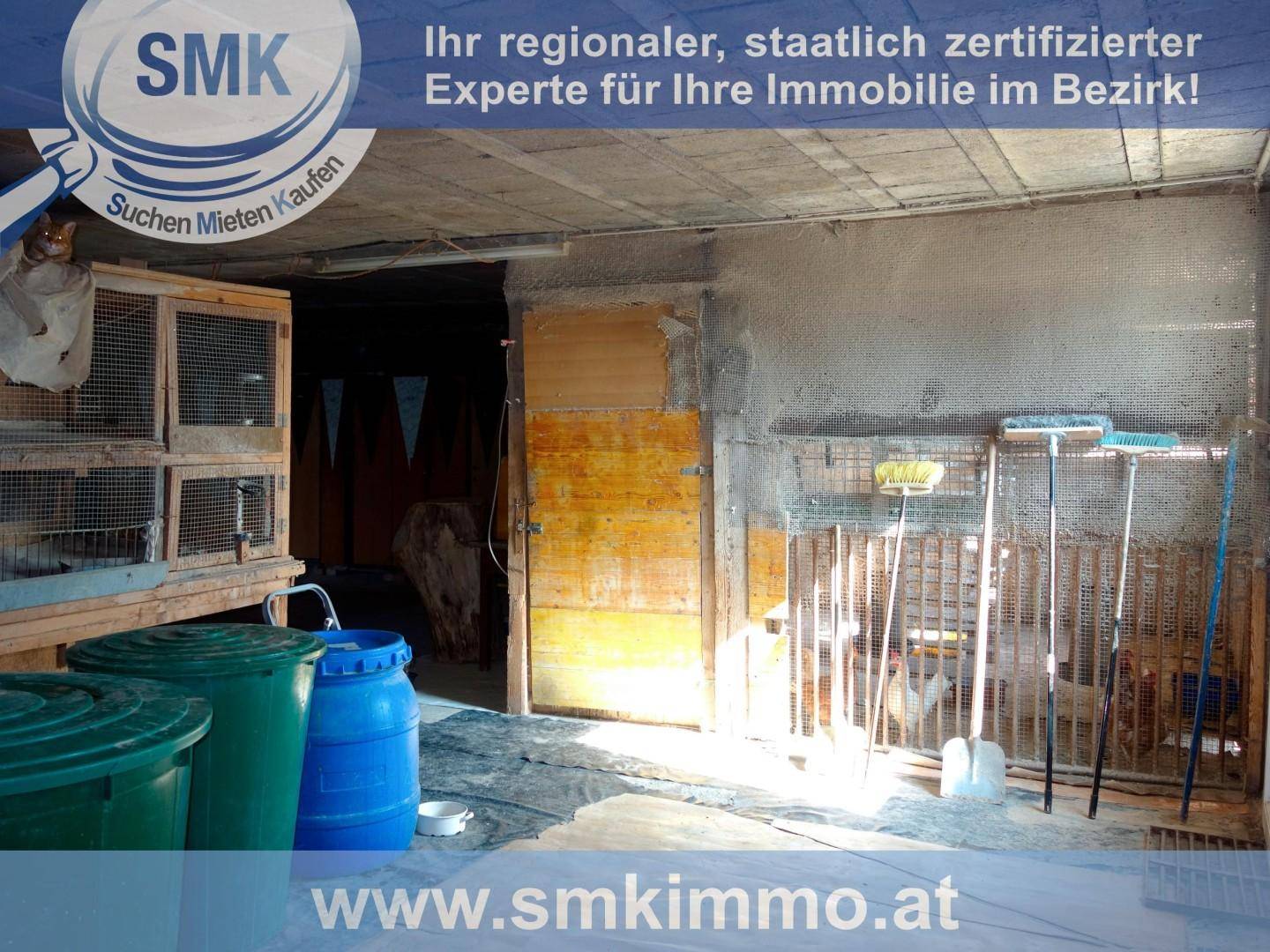 Rustikaler Innenraum, möglicherweise ein Wirtschaftsraum, mit Tierkäfigen, Fässern und Werkzeugen.