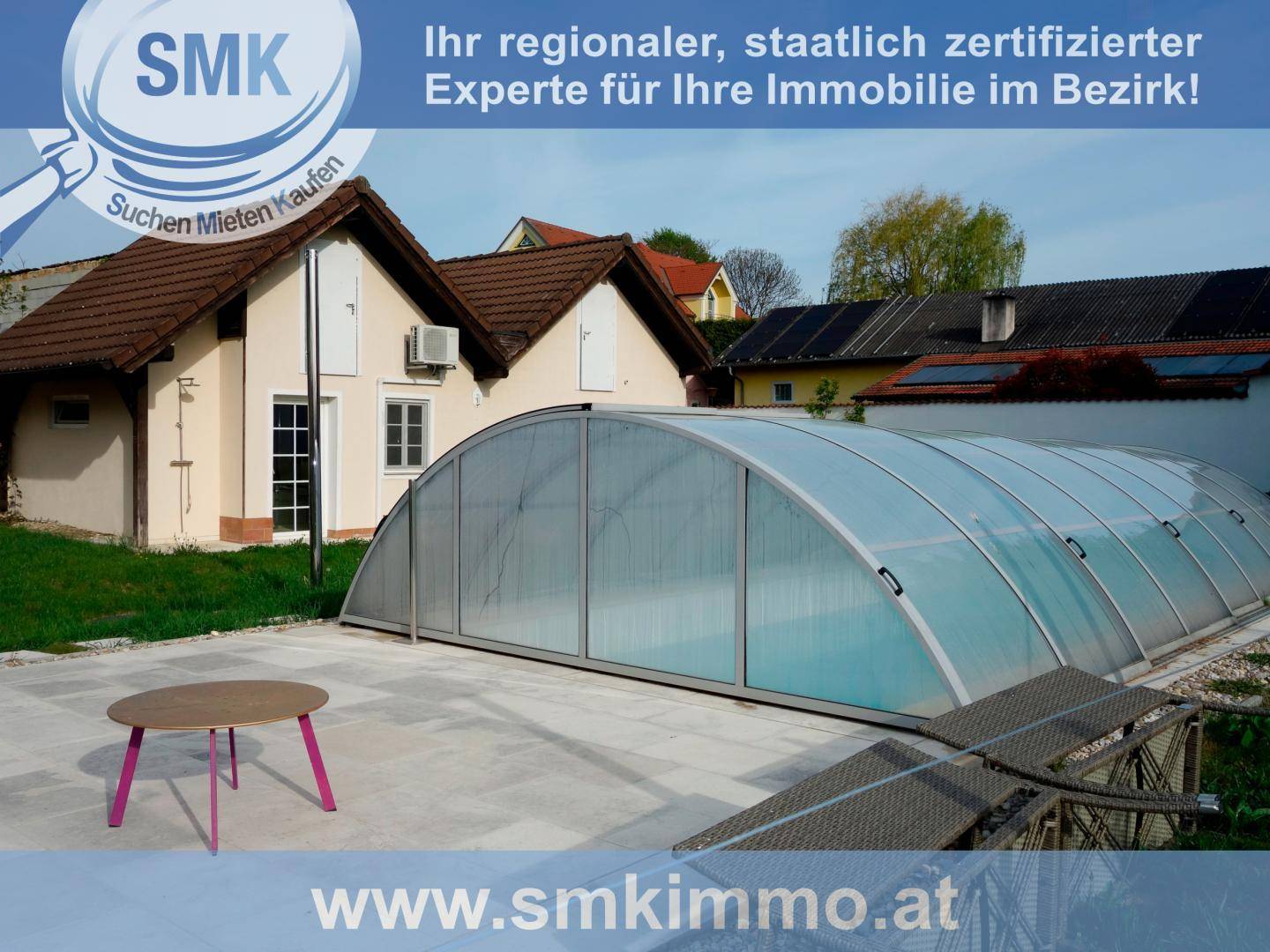 Gartenbereich mit überdachtem Pool, gepflasterter Fläche und Sitzgelegenheit im Freien.