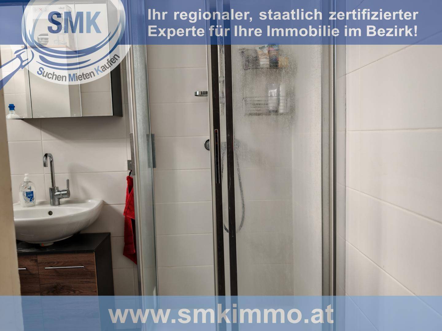 Badezimmer mit Duschkabine, Waschbecken und einem Spiegelschrank.