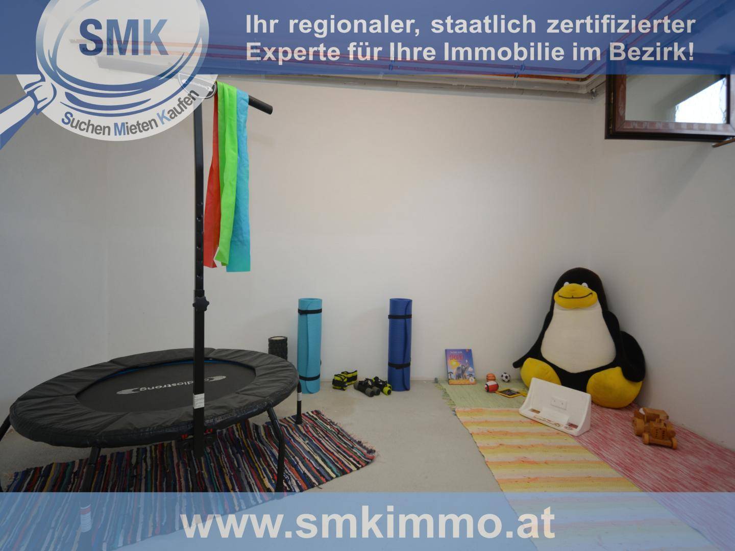 Raum im Untergeschoss mit einem Trampolin und Spielzeug, ideal als Spiel- oder Fitnessraum.