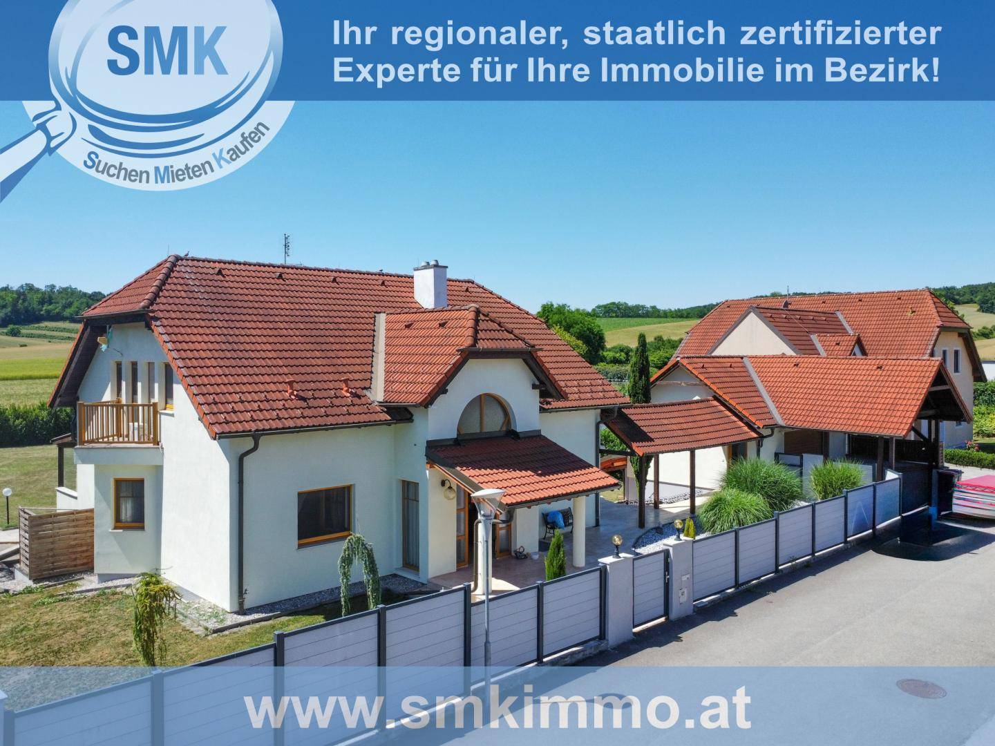 Attraktives Einfamilienhaus mit rotem Ziegeldach, weißer Fassade und gepflegtem Vorgarten.
