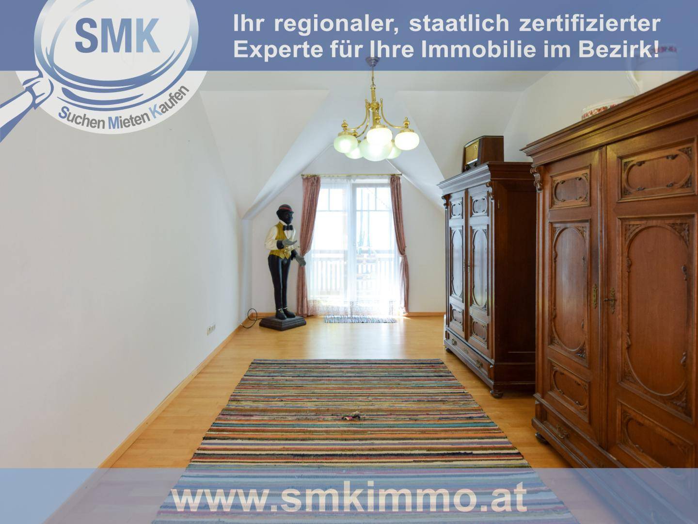 Geräumiges Schlafzimmer im Dachgeschoss mit Holzboden, großem Kleiderschrank und Dachschräge.