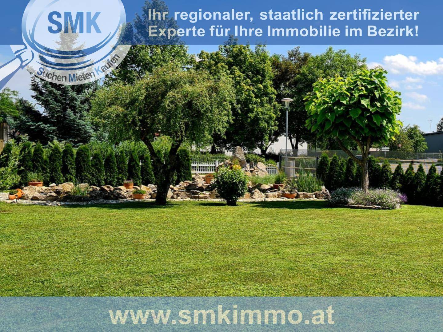 Weitläufiger Garten mit gepflegtem Rasen, Bäumen und Hecken in sonniger Lage.