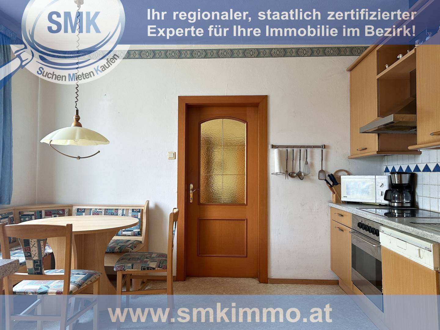 Helle Küche mit Essbereich, Holzmöbeln und funktionaler Ausstattung.