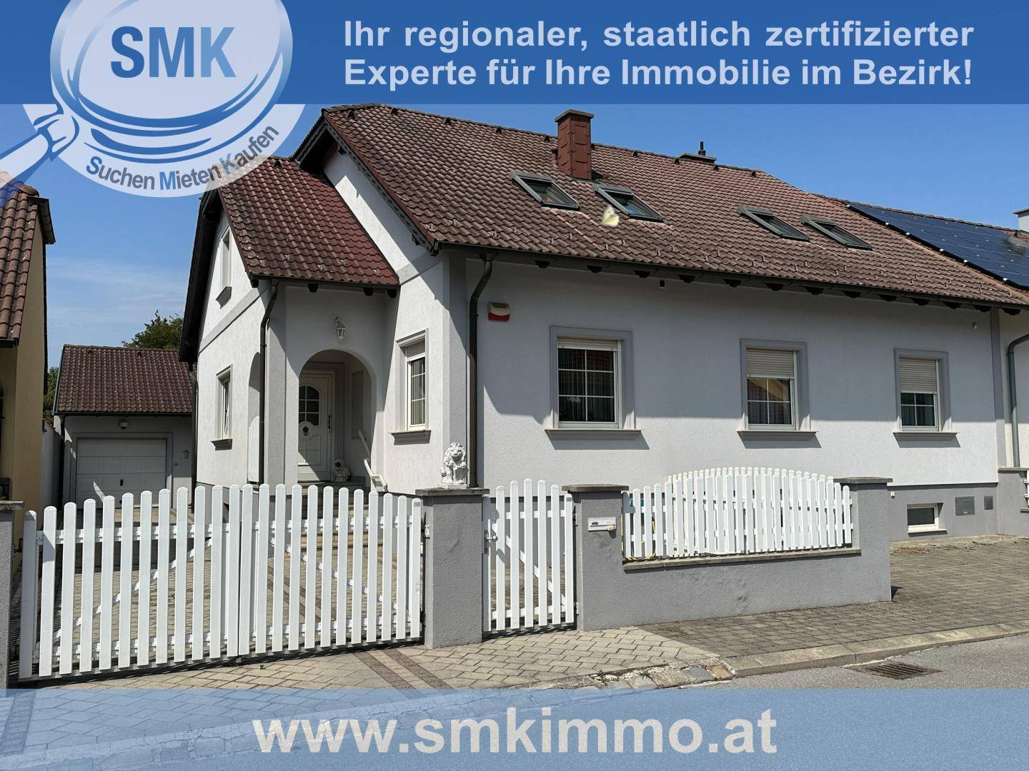 Attraktives Einfamilienhaus mit weißer Fassade, Satteldach und gepflegtem Vorgartenbereich.