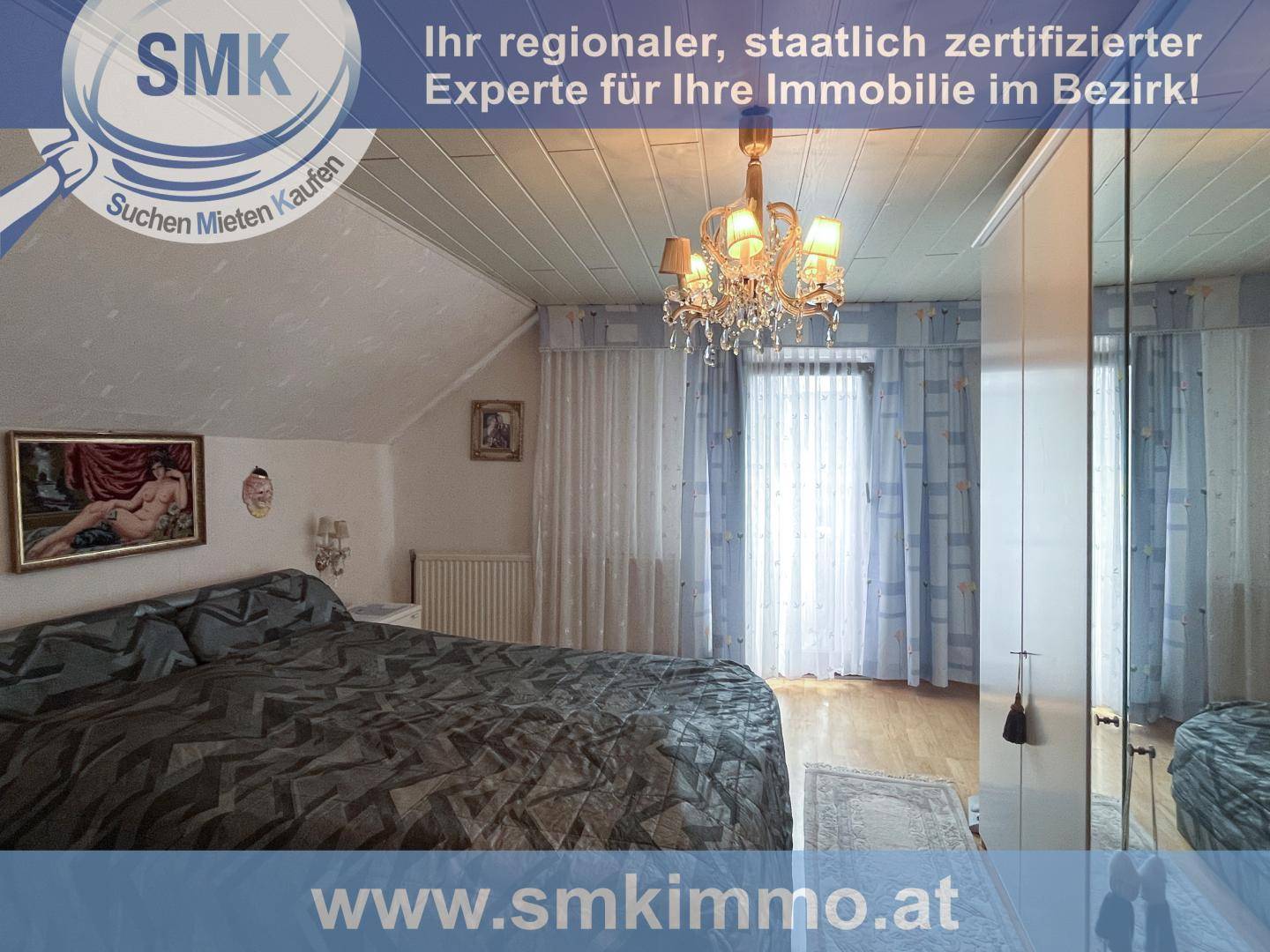 Schlafzimmer im Dachgeschoss mit Doppelbett, Spiegelschrank und Fenster mit Vorhängen.