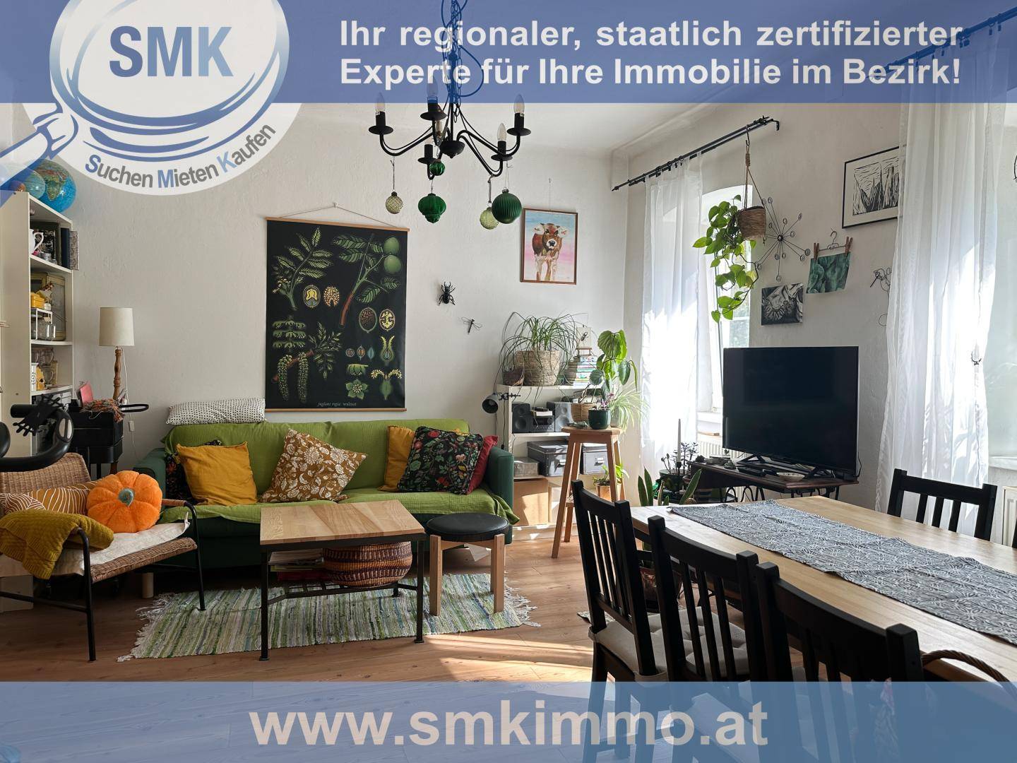 Heller Wohnbereich mit grünem Sofa, Couchtisch und dekorativen Pflanzen.
