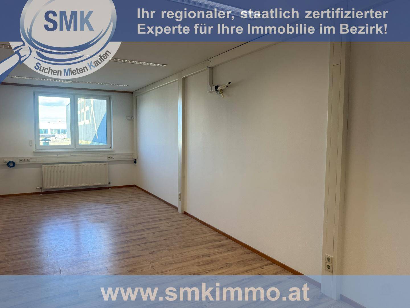 Heller Büroraum mit Laminatboden und großem Fenster, ideal für verschiedene Geschäftsnutzungen.