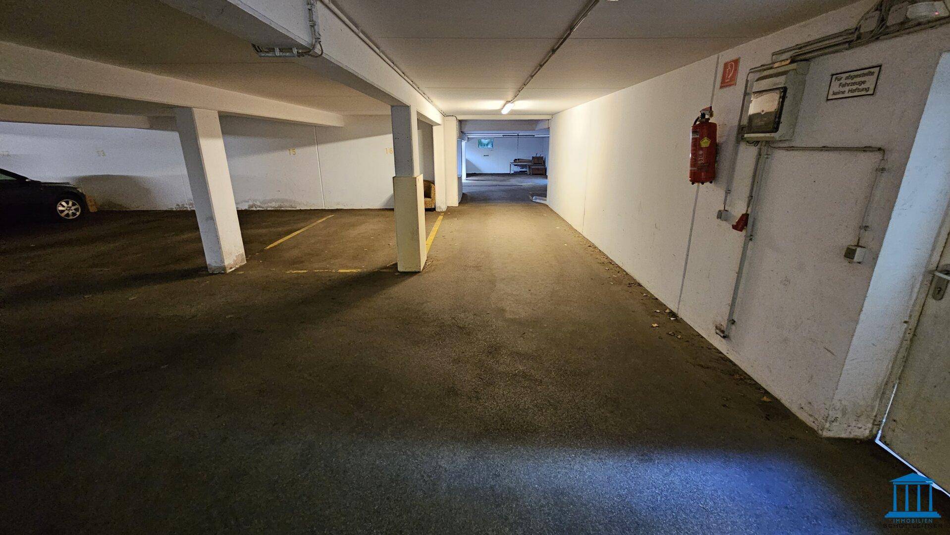Tiefgarage mit Betonpfeilern und Stellplätzen, bietet sicheres Parken für Fahrzeuge.