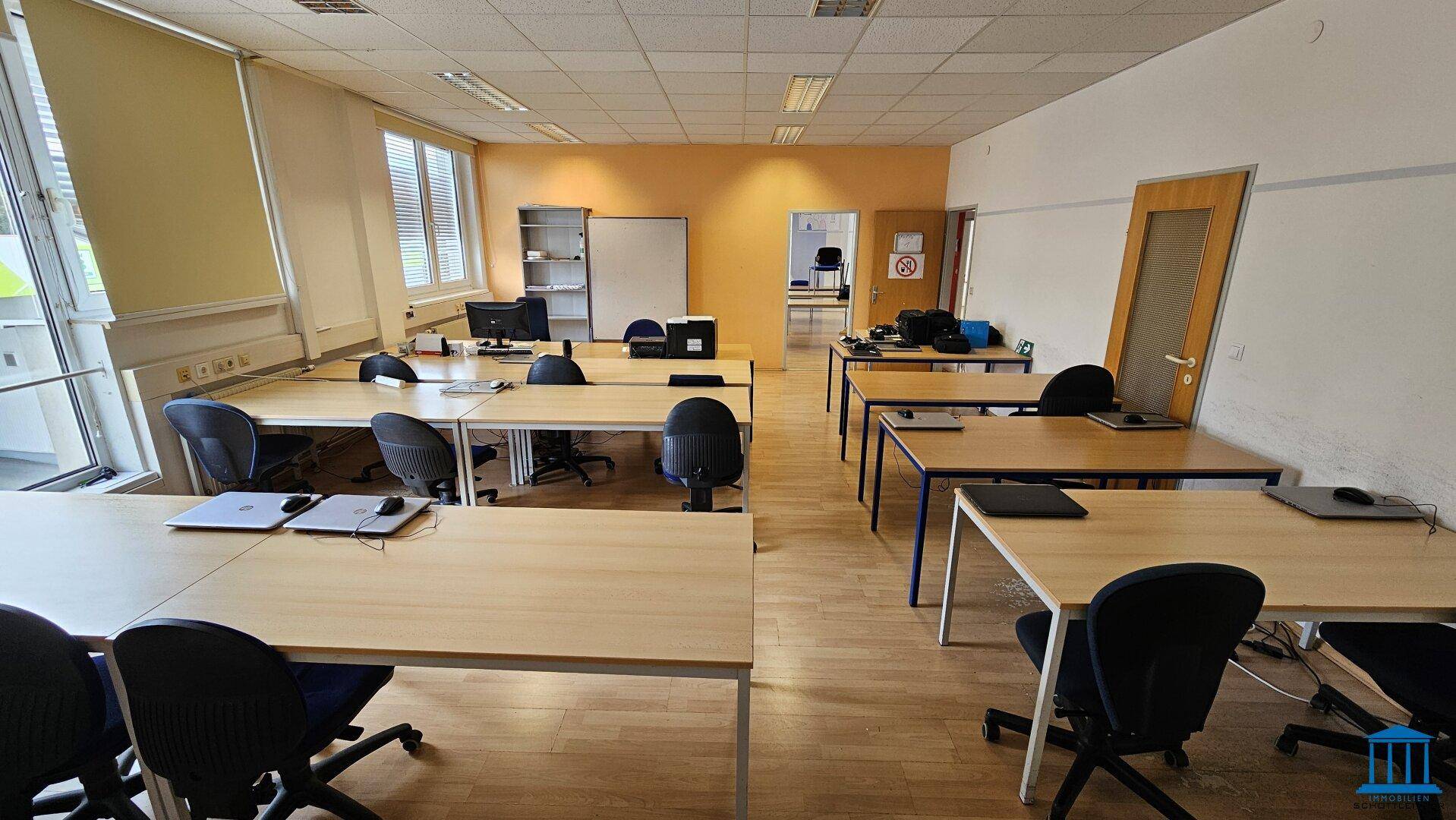 Geräumiges Büro mit vielen Arbeitsplätzen und Computern, ideal für ein Team oder mehrere Mitarbeiter.