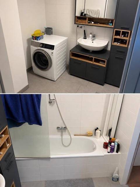 Modernes Badezimmer mit Waschmaschine, Waschtisch und Badewanne mit Duschfunktion.