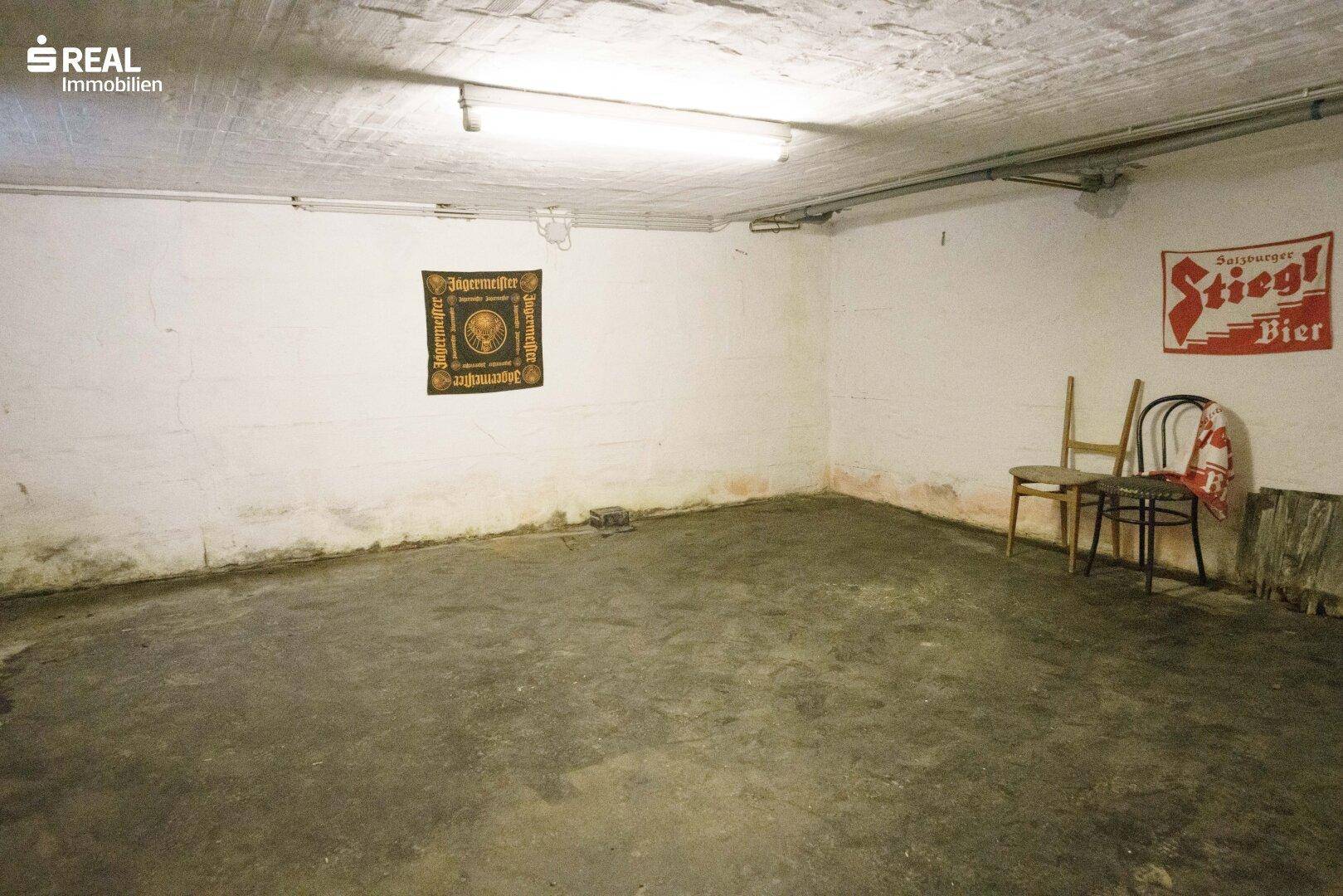 Kellerraum mit Betonboden und einfachen Wänden, bietet zusätzlichen Stauraum.